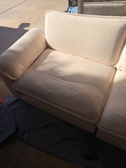 Cream-colored couch w/ upholstered ottoman