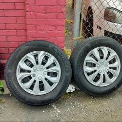 Matching set of (4) 215-65-16 tires with 5 lug wheels and hub caps