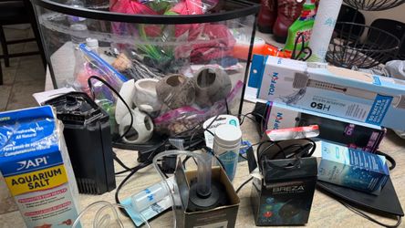 Aquarium kit with decorations, pumps, filters, and fish medicine