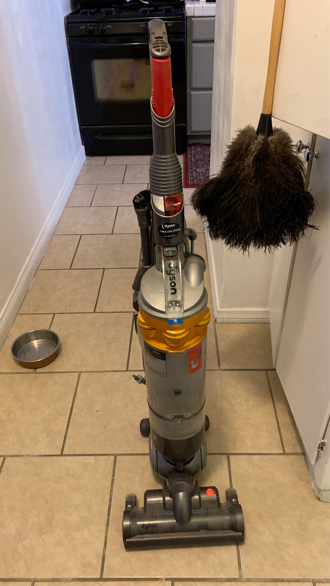Two Dyson Slim vacuum cleaners red and gold