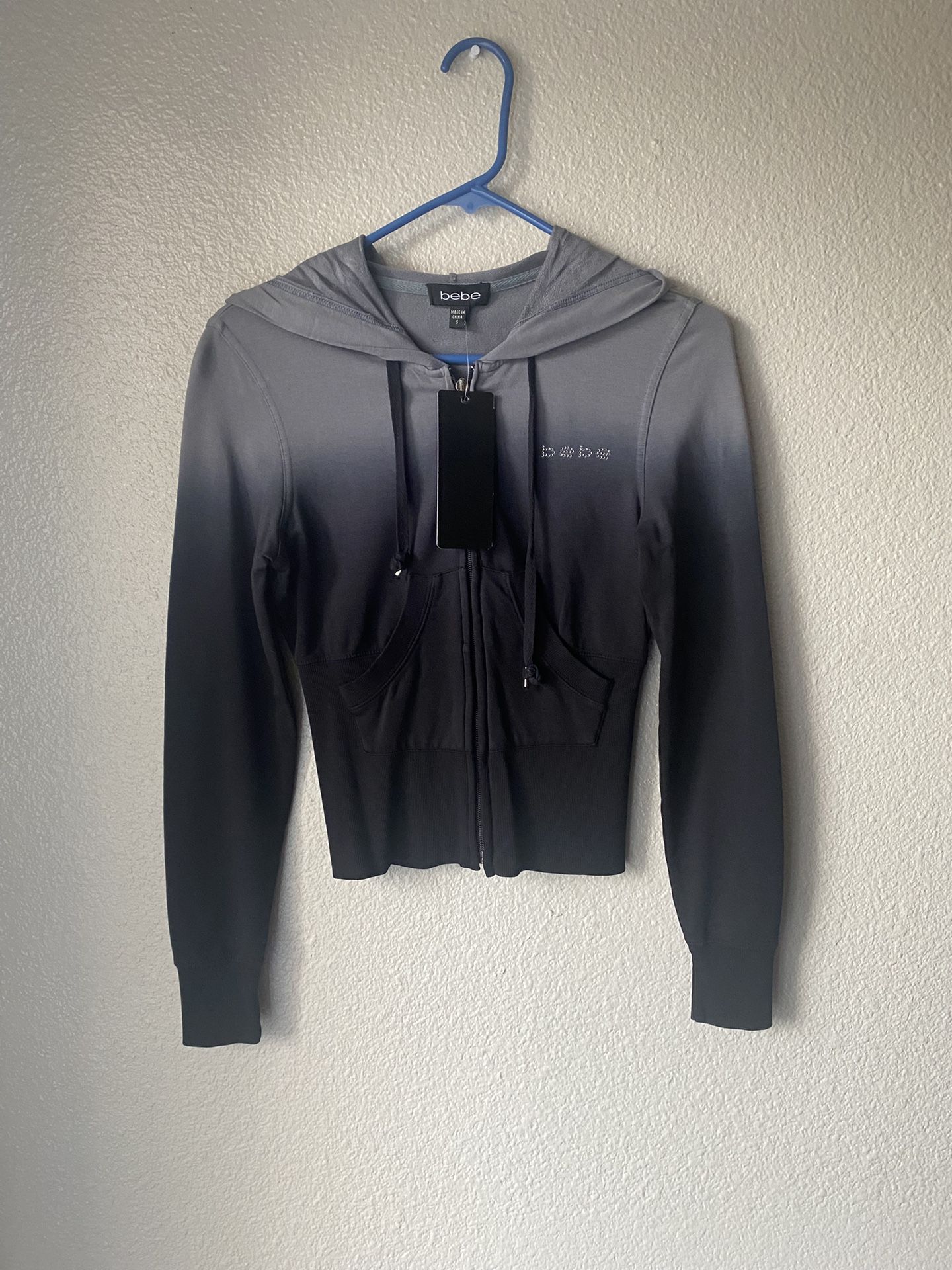 Brand new woman’s Bebe brand black and Gray colored tie dye jacket up for sale