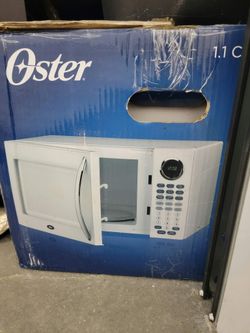 Oster 1.1 cubic 1000 watt microwave new in the box box is dirty and damaged from being in storage