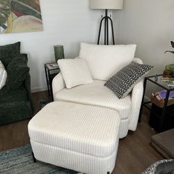 Cream colored, swivel chair with ottoman