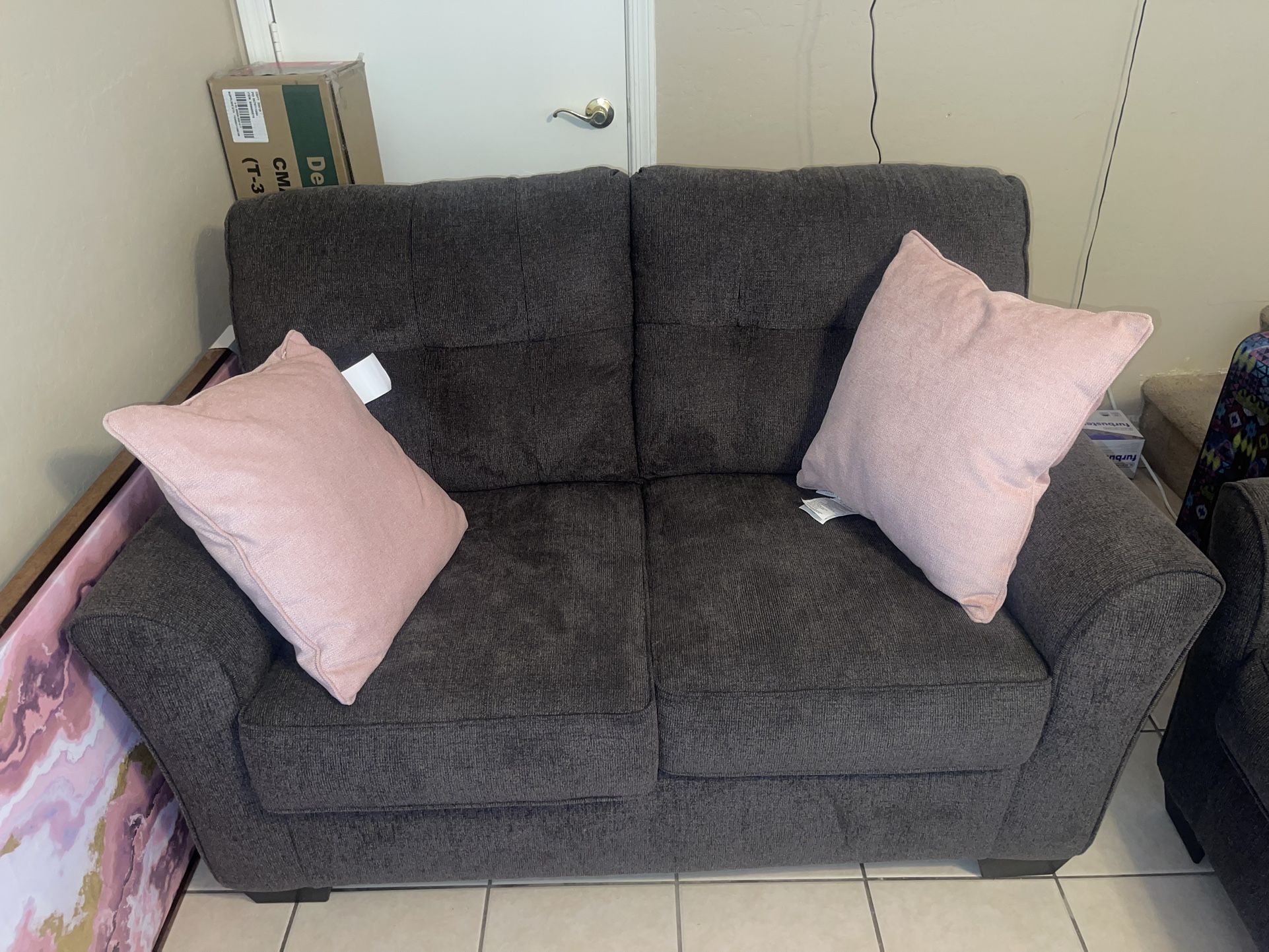 gray couches with pillows included