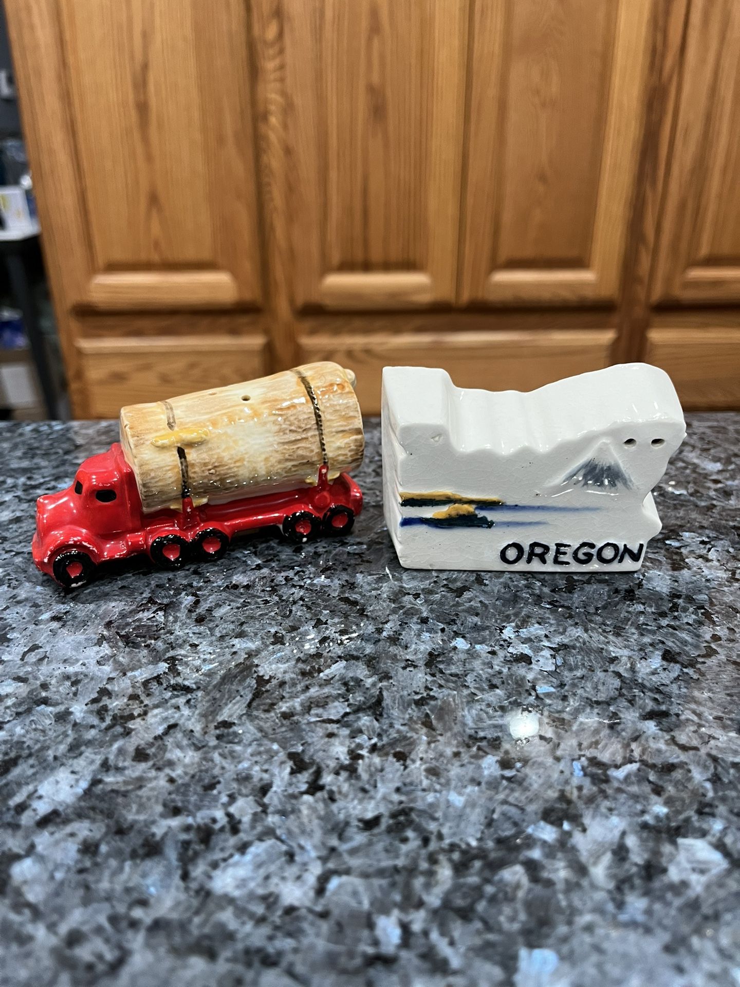 Ceramic Oregon State Souvenir shape and log truck pair of Salt and Pepper Shakers. Preowned never used with cork stoppers. Some minor pair wearing