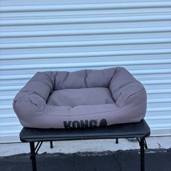 KONG®️ 4-Sided Cuddler Dog Bed featuring durable grey fabric and reinforced seams.u Dimensions 27”x20”  Small or Medium pets.
