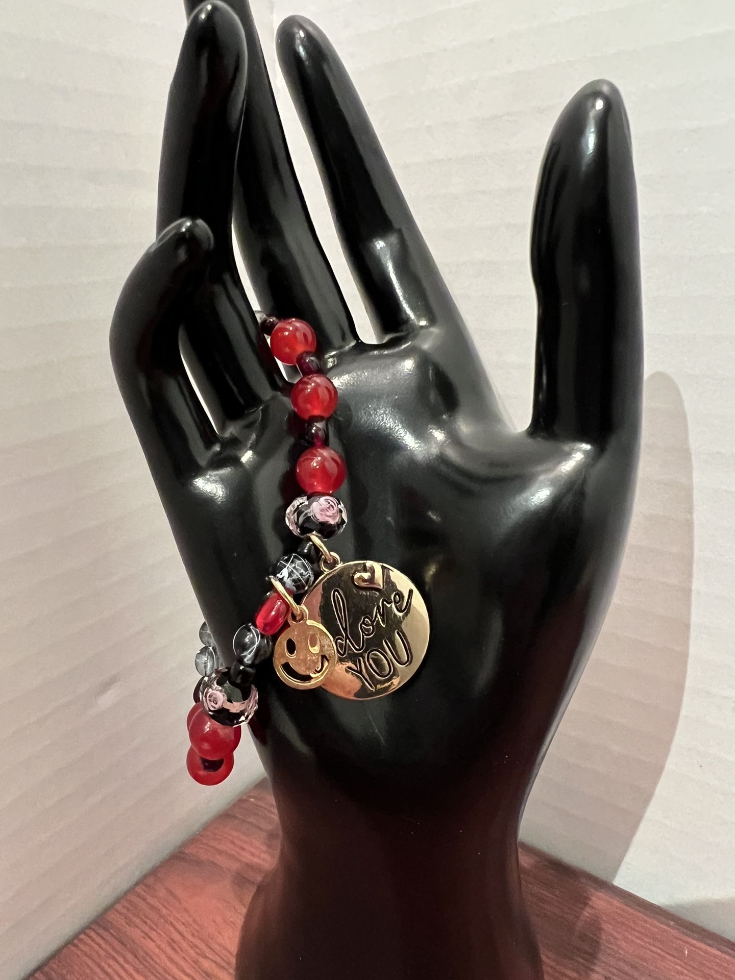 Multicolor red and black bracelet with gold accessories
