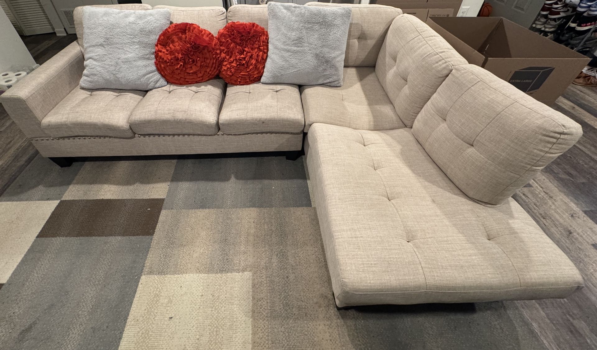 L-Shaped Beige Couch With Pillows