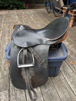 Dressage saddle with stirrups and leathers