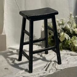 Single black saddle-seat counter height stool