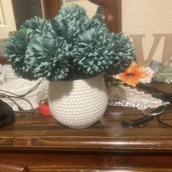 Vase with teal flowers
