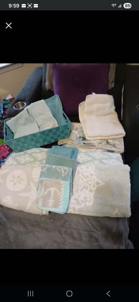 Four thick And Thirsty Luxurious towels, 6 washcloths, three hand towels, a bath mat, a shower curtain, and a bin