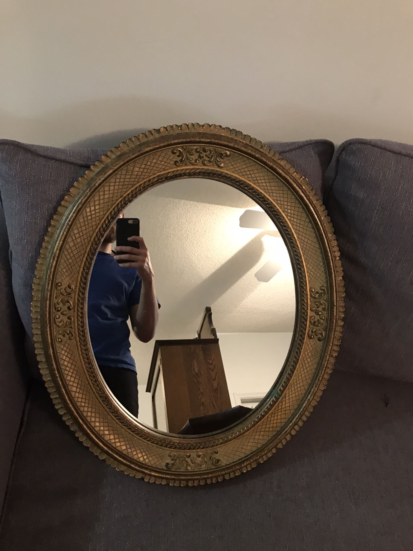 Mirror oval in a gold frame antique.