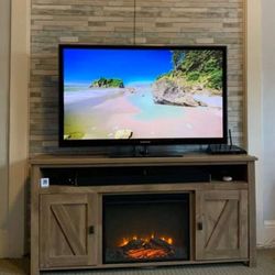 Electric Fireplace New in Original Packaging Accommodating TVs up to 60”.