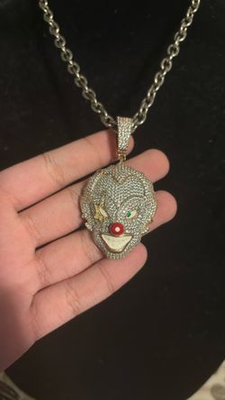 Iced out clown face pendant.