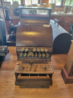 This is an early 20th-century vintage National mechanical brass cash register.