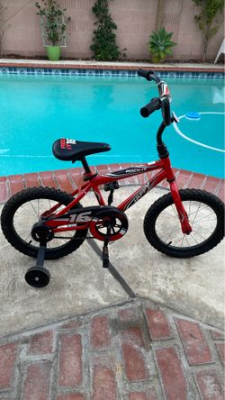 Boys huffy bike with training wheels in good condition