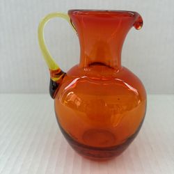 Hand blown glass orange/yellow pitcher 4 1/2” tall excellent condition