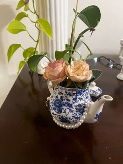Beautiful Mini Teapot with Blue and White Floral Design and some Plants with a white set of Pearls
