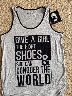 Marilyn Monroe brand graphic long tank top features a heather gray fabric with black contrasting trim and a "Give a Girl the Right Shoes" quote printe