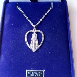 Sterling Silver infant of Prague Medal on an 18 inch stainless steel chain. Medal is rhodium plated so it will never tarnish. Religious jewelry.