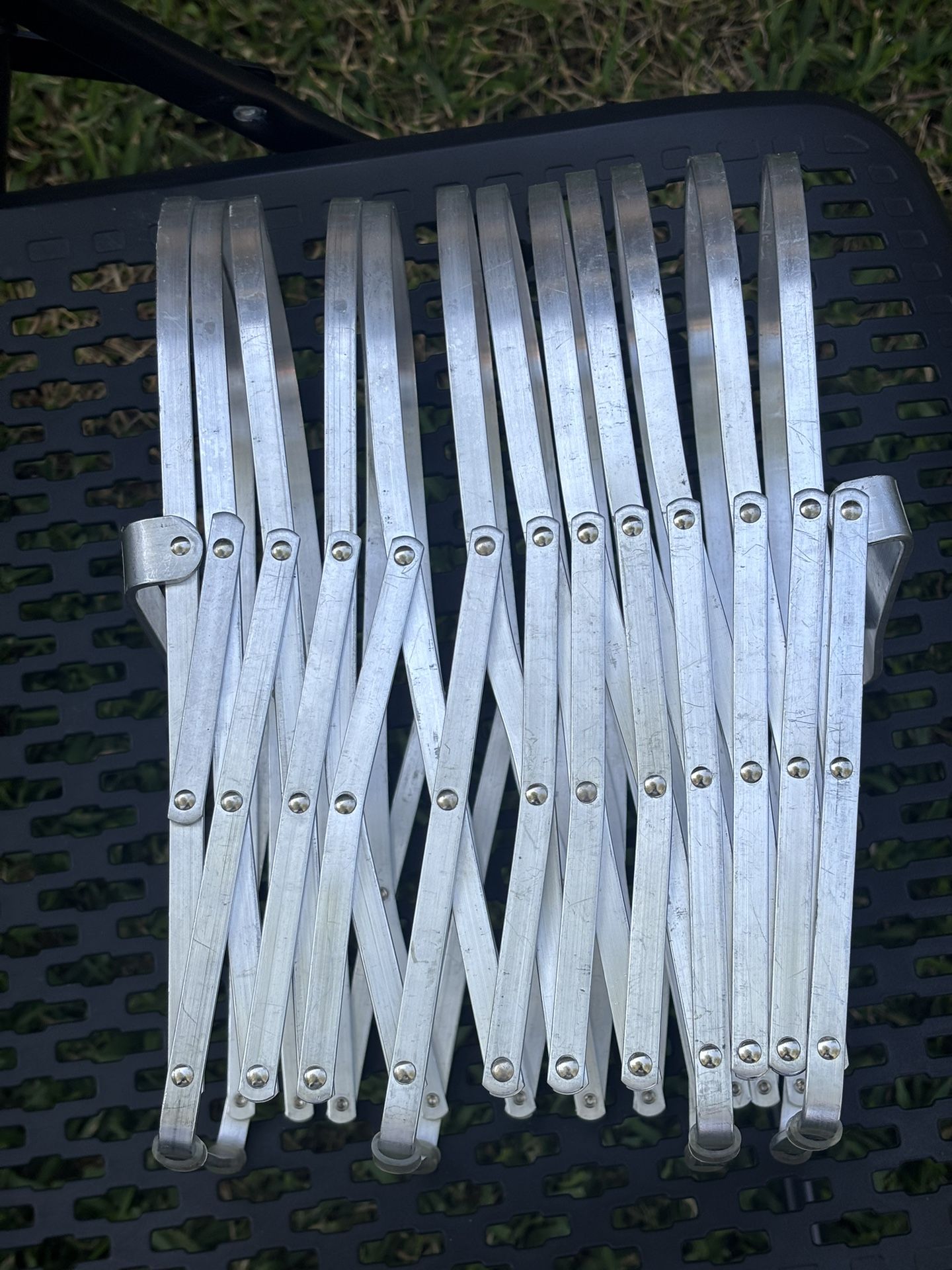 Cool, industrial mid modern look Vintage aluminum metal accordion rack by Evans Specialty. Great for magazines and albums Stretches out to 48 inche