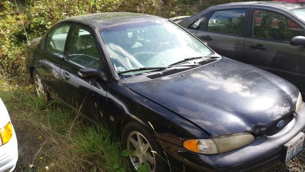 1996 Ford Contour. 2.5 V6 dual overhead cam with 5 speed transmission