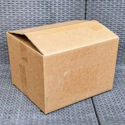 Clean small size cardboard box with peanuts for shipping moving or storage