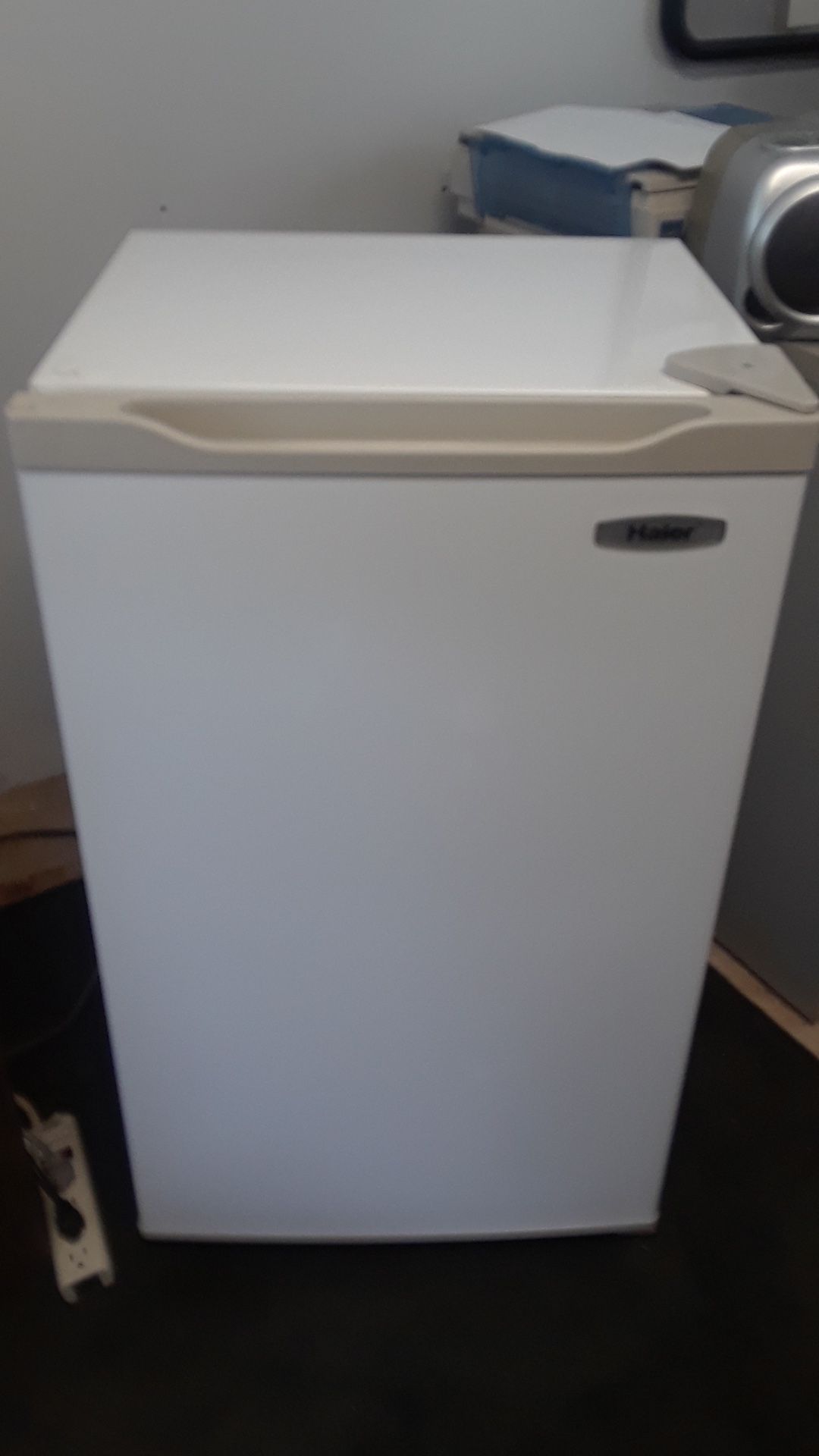 Haier mini refrigerator Size is depth 14inch, high 33 in. Width 20in.