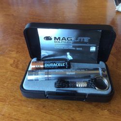 A mine flash Light with batter in its Owen case  