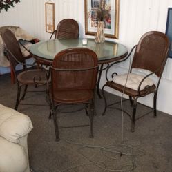 Wrought Iron Table With Half Inch Beveled Glass 4ft Four Chairs With Wicker, One Needs Repair. 