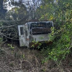 Old Camper Been Sitting Walls and Roof Are Solid. Would make A Good Hunting Shelter