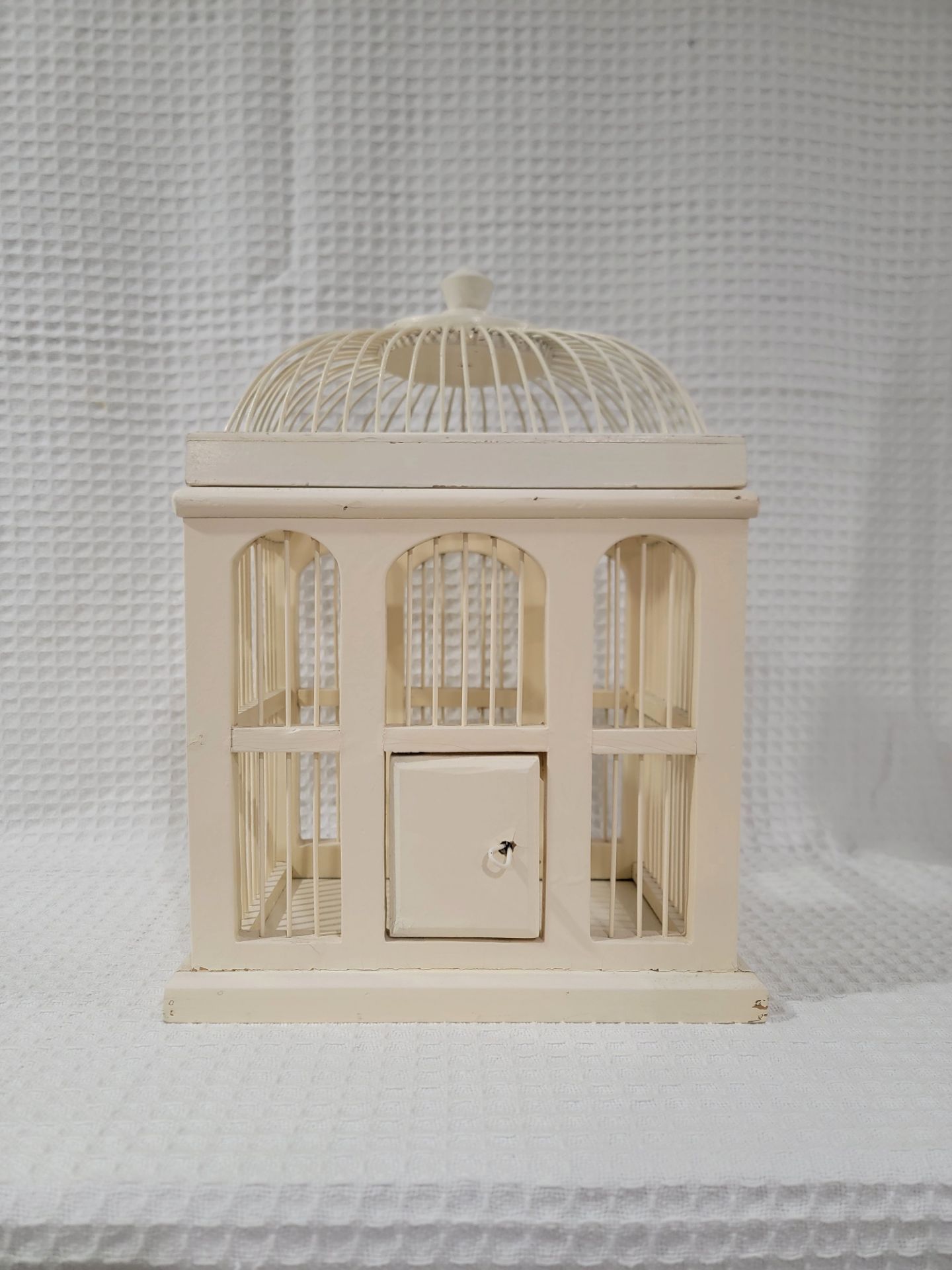 Decorative vintage-style birdcage. Made of wood, cream-white color, and medium size.