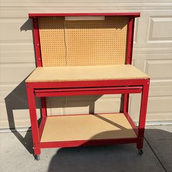 Red rolling workbench with pegboard