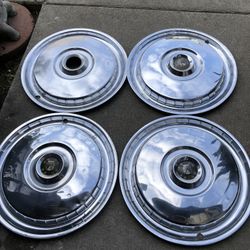 set of four vintage, 15-inch chrome hubcaps for the 1955–1956 Ford Fairlane and Thunderbird models. 