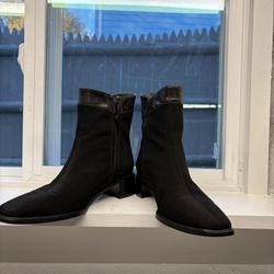 Beautiful pair of Stuart Weitzman black ankle boots in size 5.5M. These are high-quality designer boots featuring a stretch-fabric body with genuine l