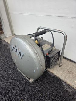 Vintage 1.5 Horsepower (HP) portable wheelbarrow or donut-style air compressor,