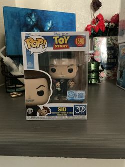 Sid from Toy Story holding woody and buzz Funko pop