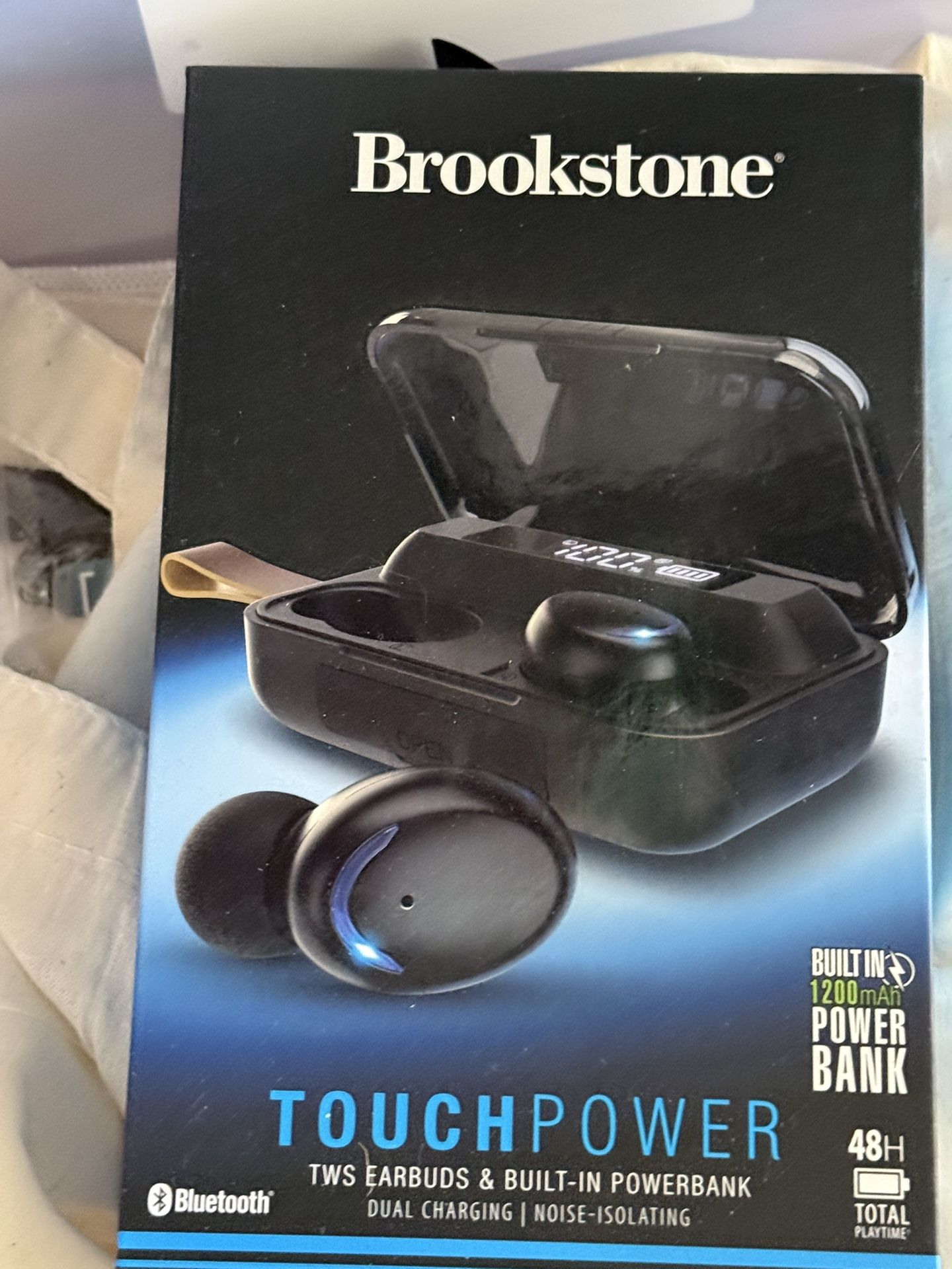 Brookstone Touchpower two earbuds and power bank