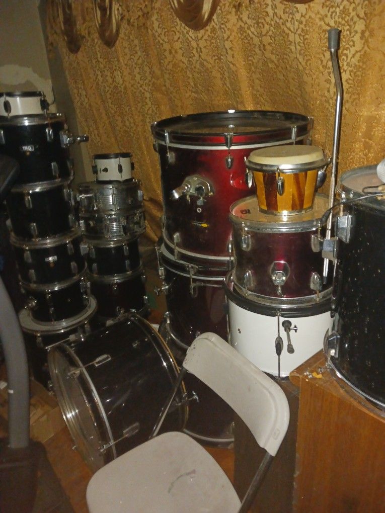 Two Sets Of Drums With Legs And Seat