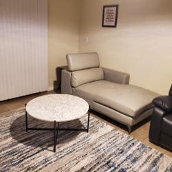 Cream colored sofa and two different coffee tables
