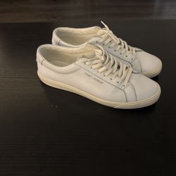 These are Saint Laurent Andy sneakers in white leather, a popular low-top style from the French fashion house. They are a minimalist design featuring 