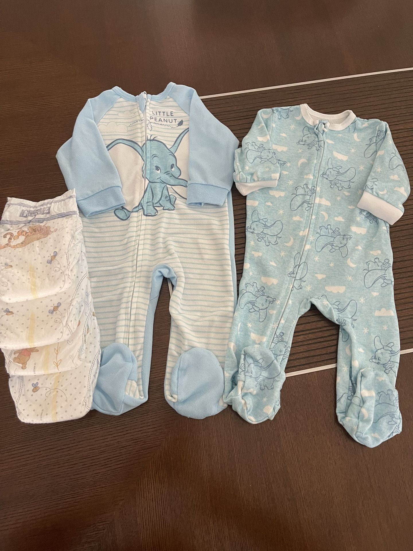 Two DISNEY footies with four Huggies Diapers(size2), 3 mo