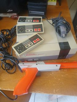 Original Nintendo nes system with 3 remotes  and 6 games