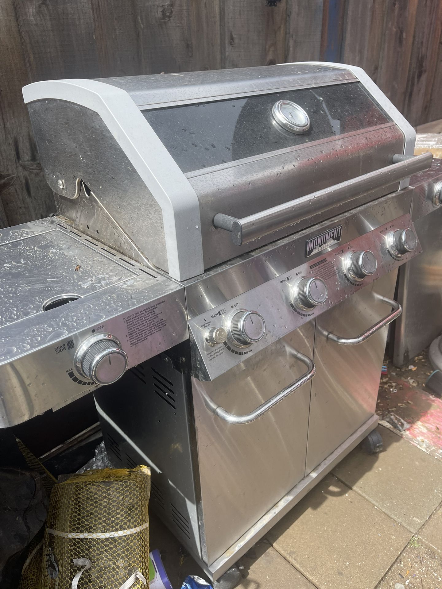 Monument Clearview Stainless Steel 4-Burner Liquid Propane Gas Grill with 2 Side Burners