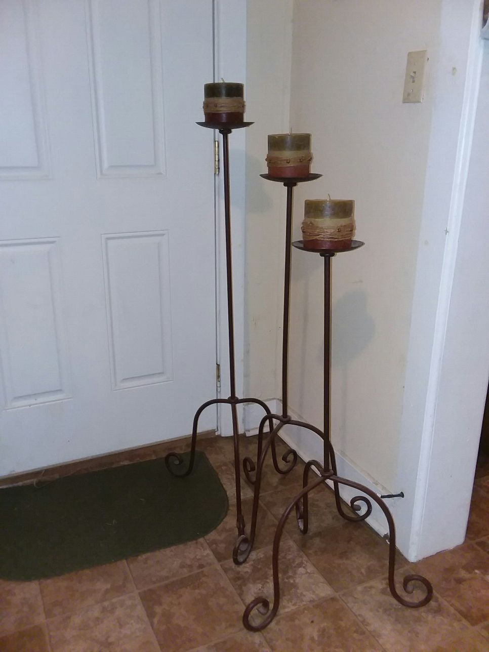 3 black and brown floor lamps with candles