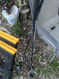 4 golf clubs and a bucket of balls