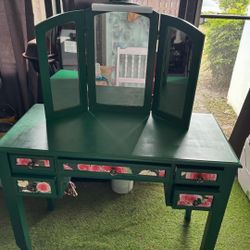  Green vanity with mirror and light.