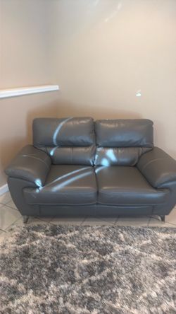 Leather Loveseat in Dark Gray brings a cozy, family friendly feel to your living space.