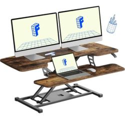 Dual monitor riser with wood finish and metal frame.

FLXISPOT 42-inch Standing Desk Converter, Sit to Stand Dual Monitor and Laptop Workstation